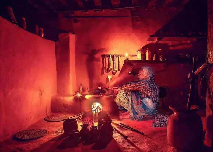 Grandmother cooking on a traditional chulha